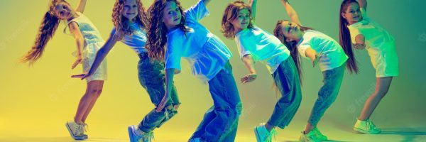 group-active-kids-cheerful-girls-dancing-isolated-green-background-neon-light_155003-46334