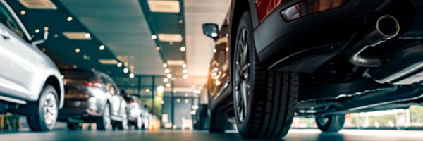 Rearview of parked cars Car dealership office. New car parked in modern showroom. Automobile leasing and insurance concept.